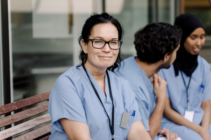 Shot of smiling female doctor looking at camera in the medical consultation.