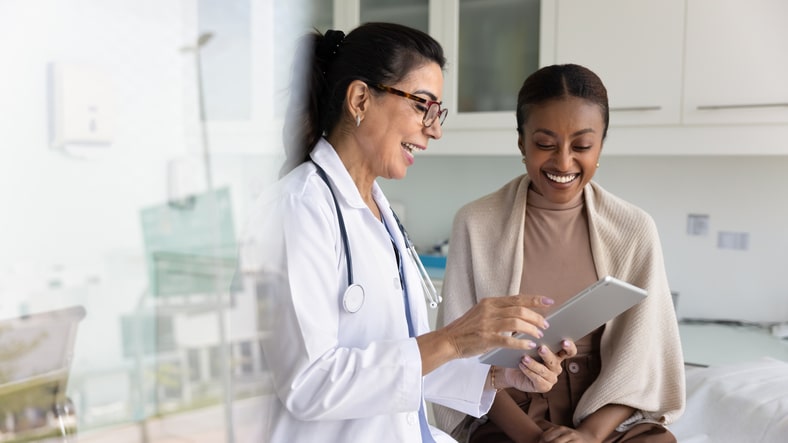 Shot of smiling female doctor looking at camera in the medical consultation.