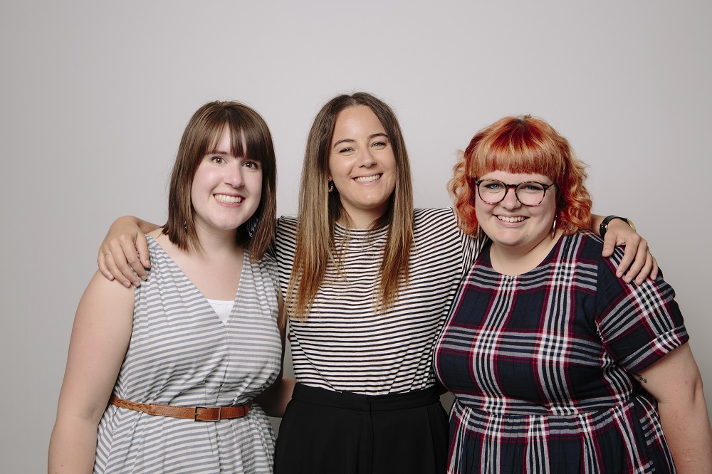 Three women smiling