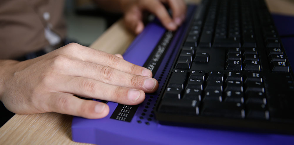 Hands of a person using an accessible keyboard